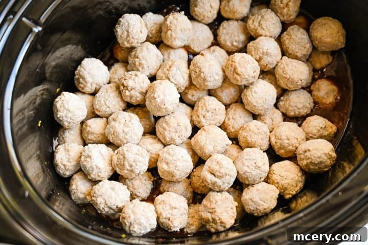 Cranberry Glazed Holiday Meatballs 6 Step 3: BBQ sauce is added to the slow cooker.