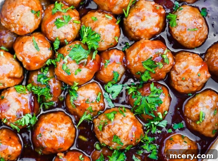 Cranberry Glazed Holiday Meatballs 8 Step 5: Meatballs are stirred in the slow cooker to coat evenly.
