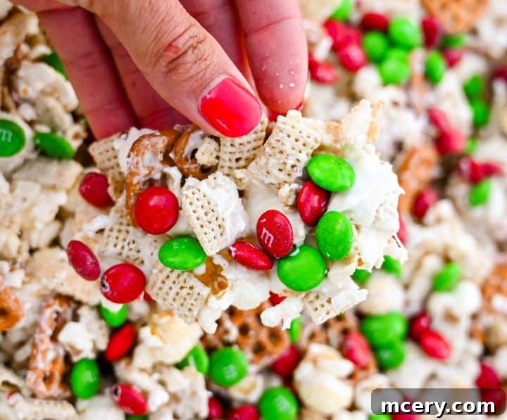 A festive bowl of Reindeer Crunch Snack Mix with various textures and colorful M&M's.