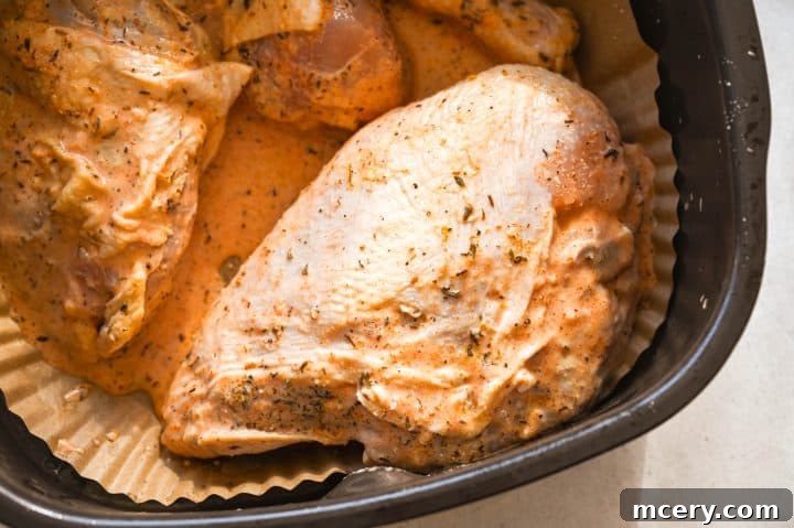 A serving of buttermilk chicken on a plate with fresh herbs.