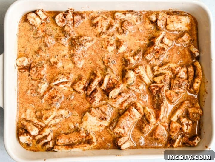 Golden Apple Cinnamon Pull-Apart Bake 11 Baked Apple Cinnamon Roll Bake with icing drizzled on top.