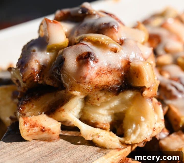 Golden Apple Cinnamon Pull-Apart Bake 15 Final plated serving of Apple Cinnamon Roll Bake with gooey icing and tender apples.