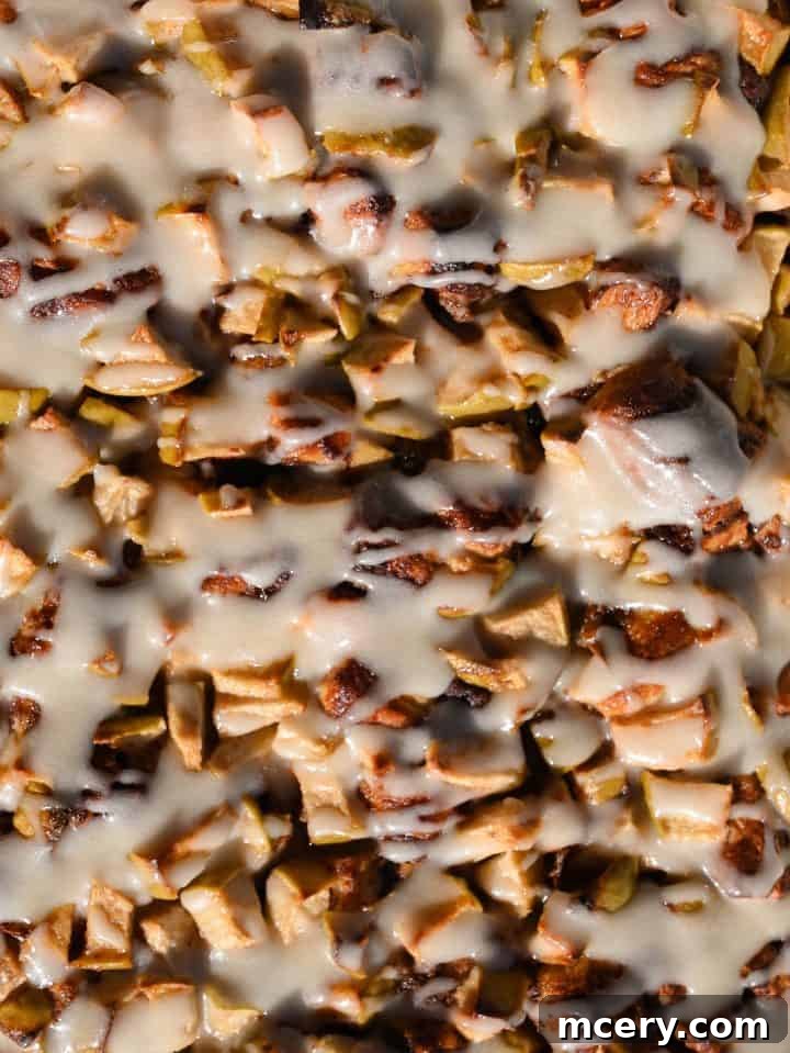 Golden Apple Cinnamon Pull-Apart Bake 3 Close-up of the Apple Cinnamon Roll Bake showing the tender cinnamon rolls, creamy custard, and soft apple pieces.