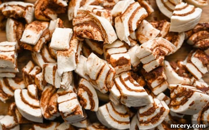 Golden Apple Cinnamon Pull-Apart Bake 5 Prep step: Quartered cinnamon rolls laid in a baking dish.
