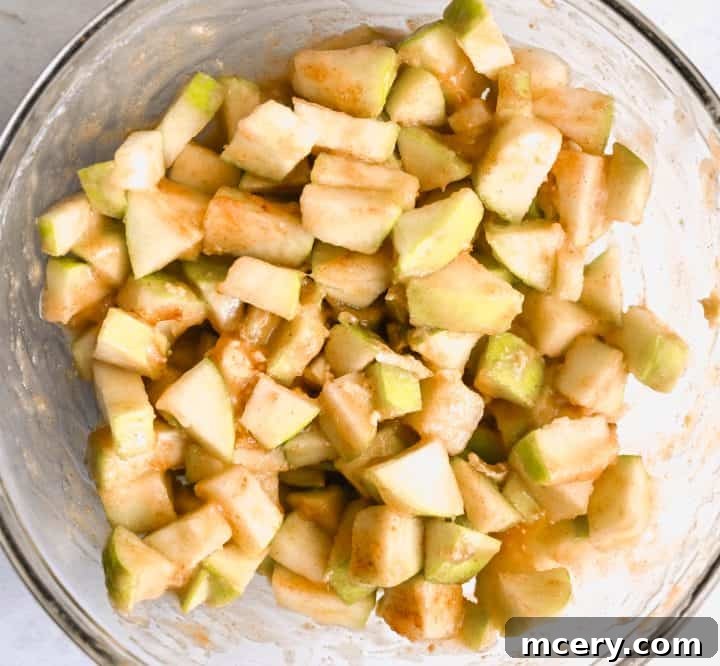 Golden Apple Cinnamon Pull-Apart Bake 9 Prep step: Spreading apple mixture over the cinnamon rolls.
