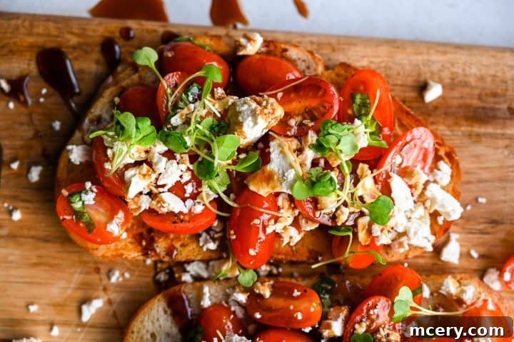 Healthy Feta Tomato Toast on a rustic wooden board