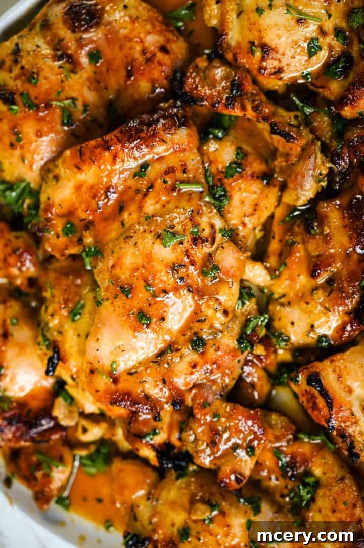 Honey Mustard Chicken One Pan Feast 2 Close up of perfectly baked honey mustard chicken thighs, garnished with fresh parsley.