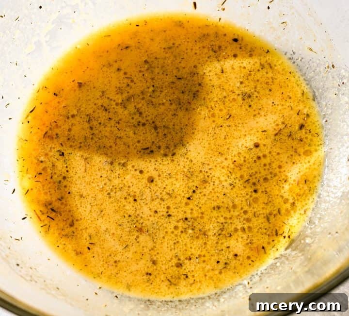 Honey Mustard Chicken One Pan Feast 5 Cooked honey mustard chicken on a sheet pan, glistening with sauce.
