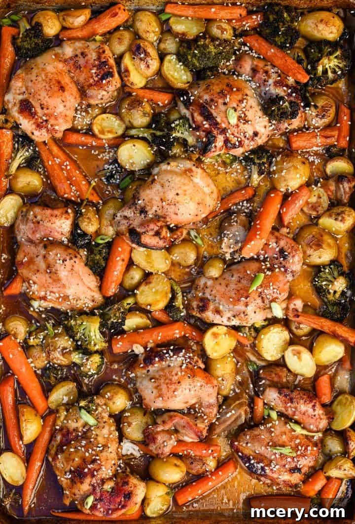 Sticky Honey Garlic Chicken and Roasted Vegetables 2 Close-up of golden brown honey garlic chicken and roasted vegetables on a sheet pan