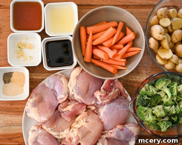 Sticky Honey Garlic Chicken and Roasted Vegetables 4 Ingredients for honey garlic chicken and veggie sheet pan dinner laid out on a counter