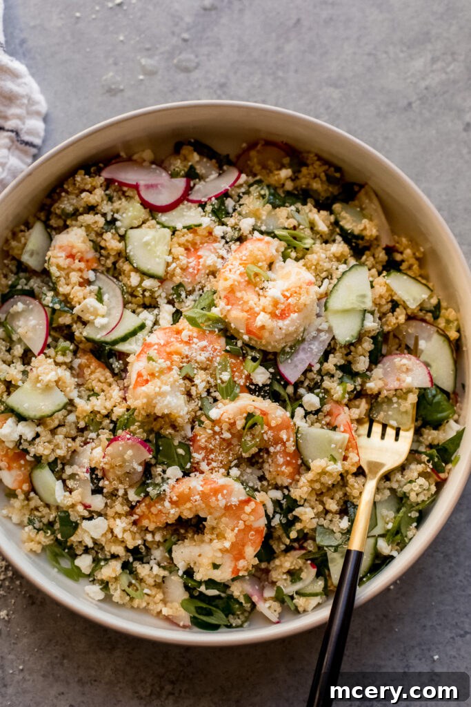 Vibrant Spring Shrimp Quinoa Bowl 2 Vibrant Spring Quinoa Shrimp Salad in a bowl, garnished with fresh herbs, showcasing colorful ingredients.