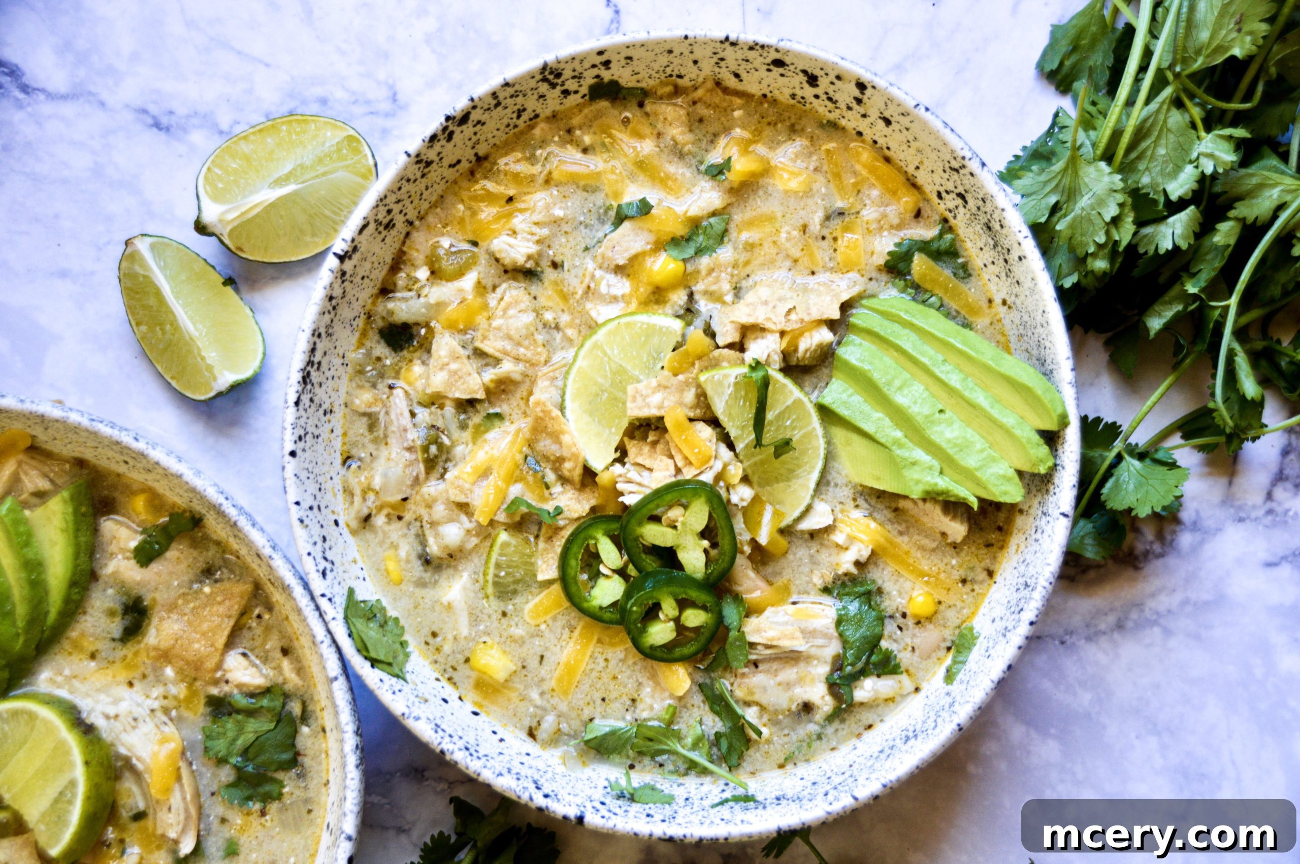Easy Instant Pot White Bean Chicken Chili 2 Instant Pot White Bean Chicken Chili garnished with fresh cilantro and a lime wedge.