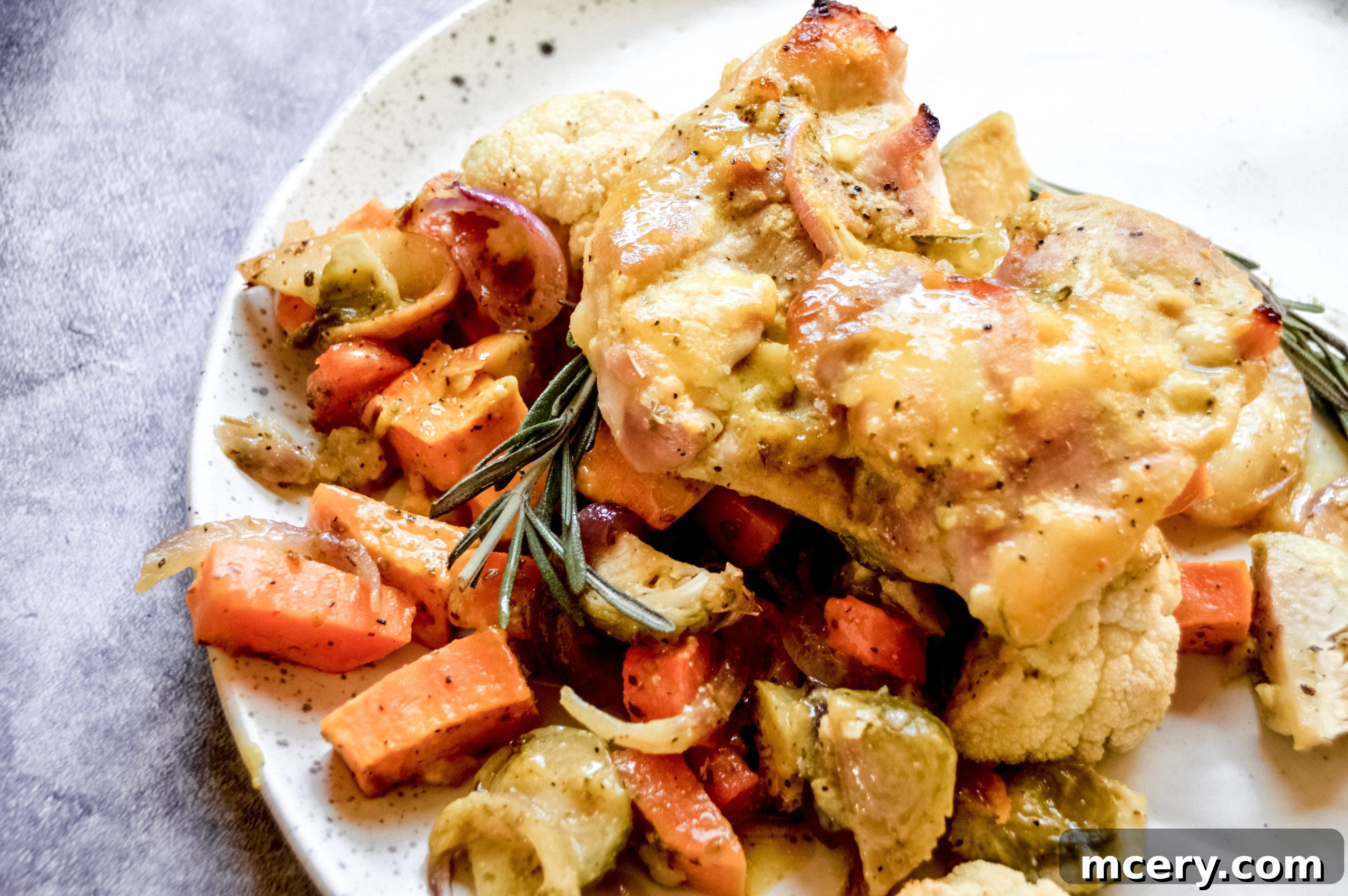 Honey-Glazed Rosemary Chicken with Flavorful Roasted Vegetables 2 A vibrant sheet pan dinner featuring Rosemary Honey Chicken with roasted sweet potatoes and Brussels sprouts, ready to be served.
