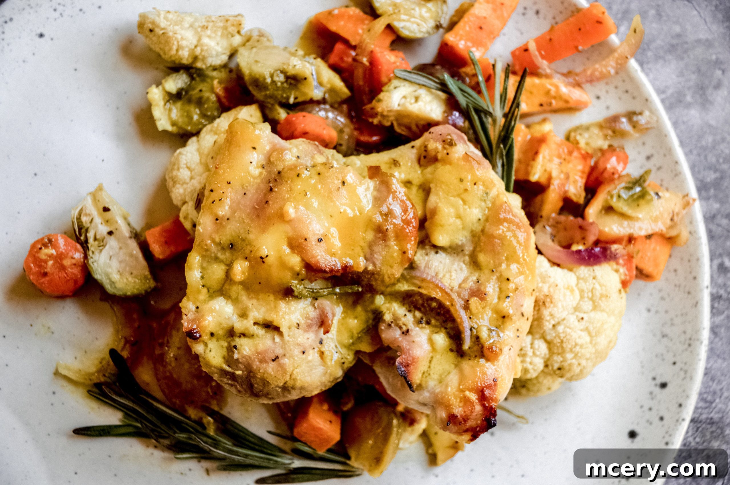 Honey-Glazed Rosemary Chicken with Flavorful Roasted Vegetables 3 A close-up of Rosemary Honey Chicken on a sheet pan, showing caramelized chicken and perfectly roasted vegetables.
