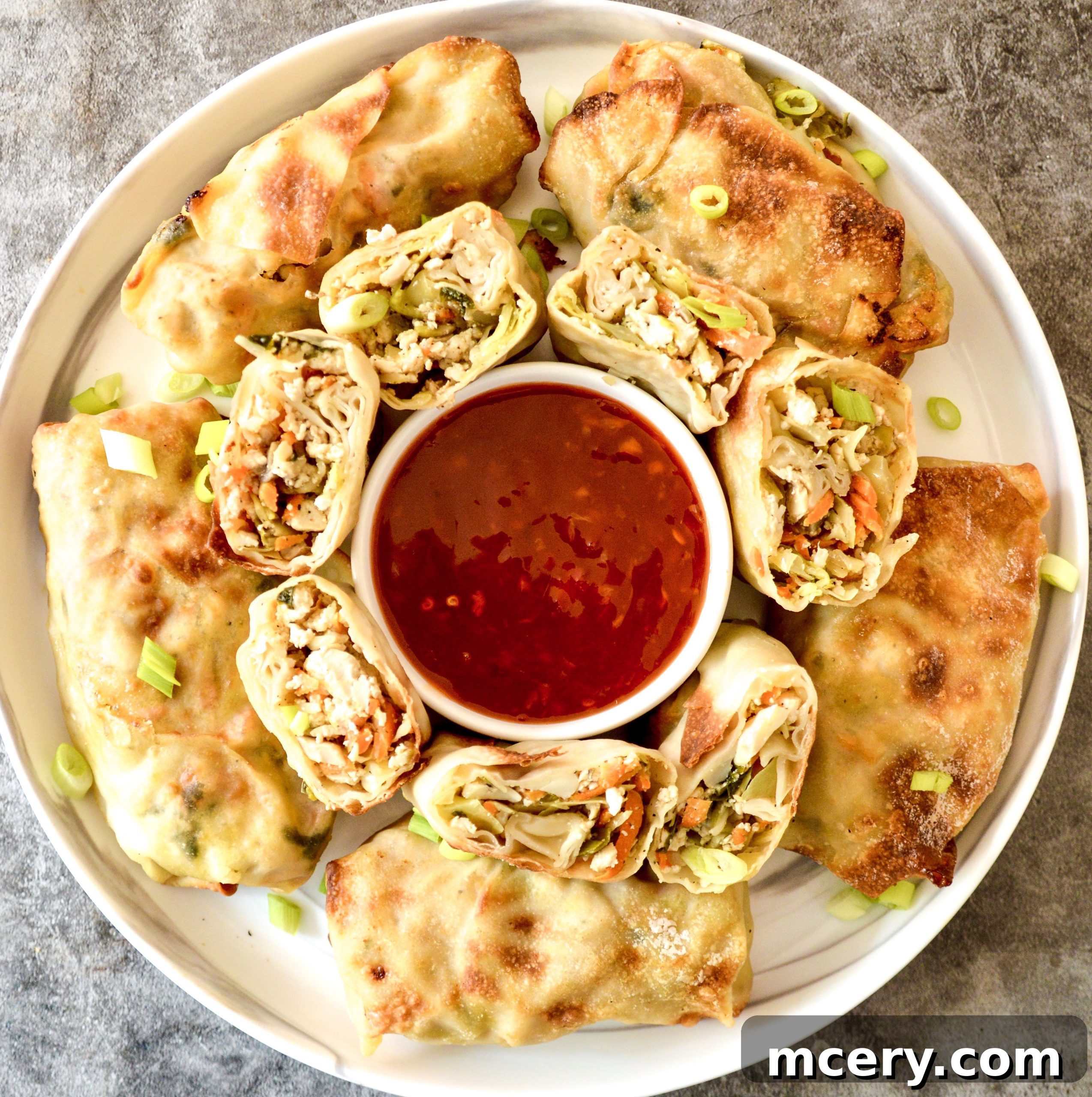 Golden Crispy Air Fryer Veggie Tofu Rolls 2 Crispy Air Fryer Egg Rolls arranged beautifully on a serving plate, ready to be enjoyed.