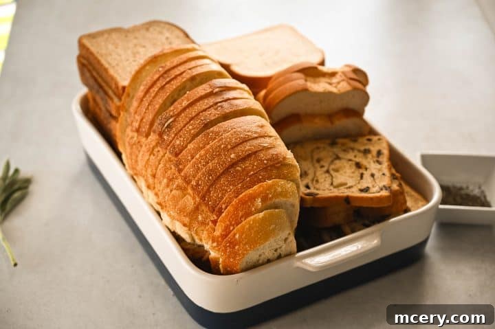 Pratik İç Harcı Tarifi: Şükran Günü Sofralarının Yıldızı 4 Dried bread cubes are mixed with fragrant sautéed aromatics and broth in a large bowl, ready for baking into the ultimate stuffing.