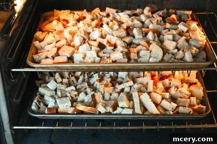 Pratik İç Harcı Tarifi: Şükran Günü Sofralarının Yıldızı 5 Cubed bread on a baking sheet, drying in the oven for stuffing.