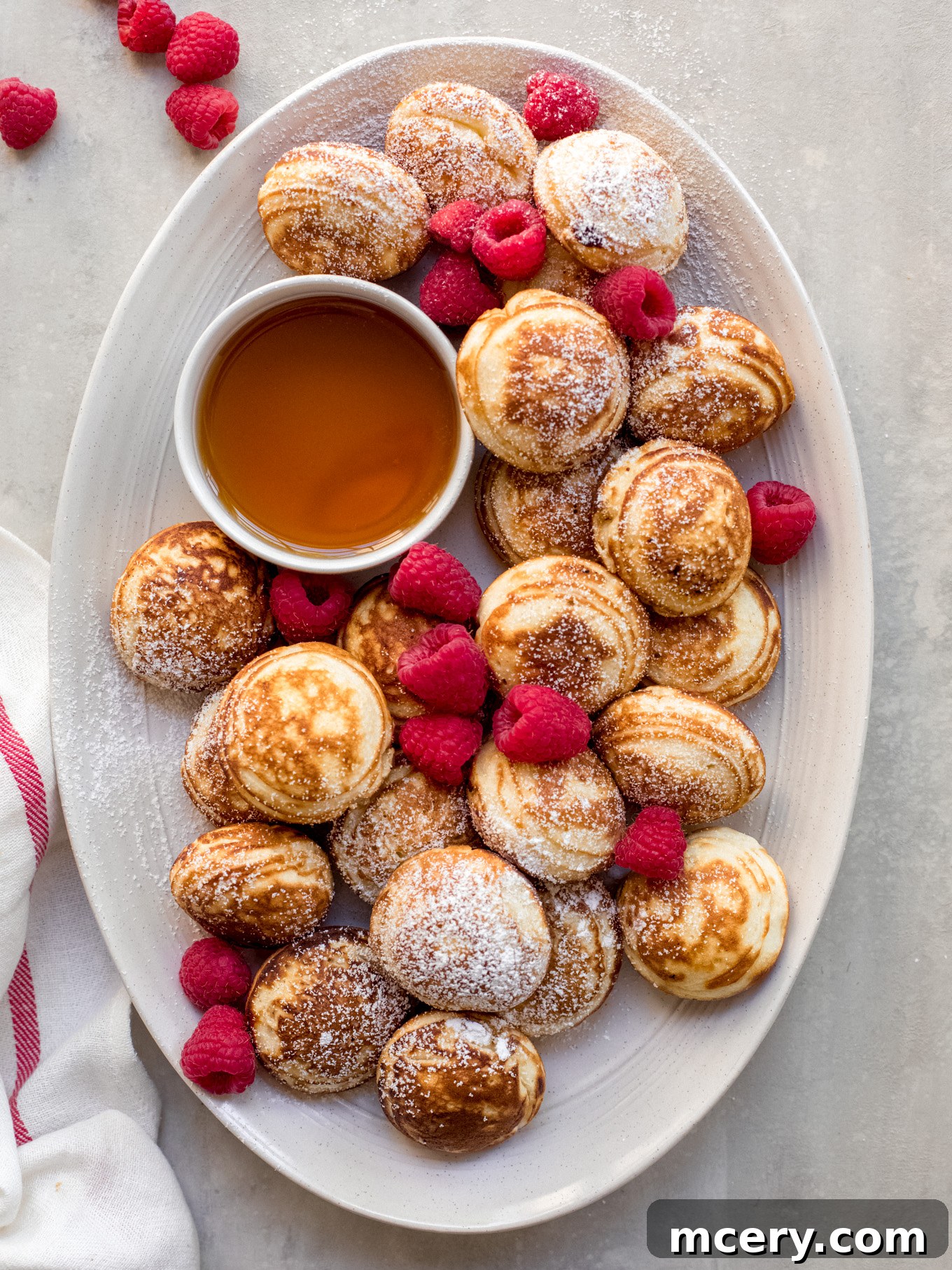 Perfectly golden and fluffy Danish pancakes (Æbleskiver) arranged on a plate, ready to be served for breakfast or brunch.