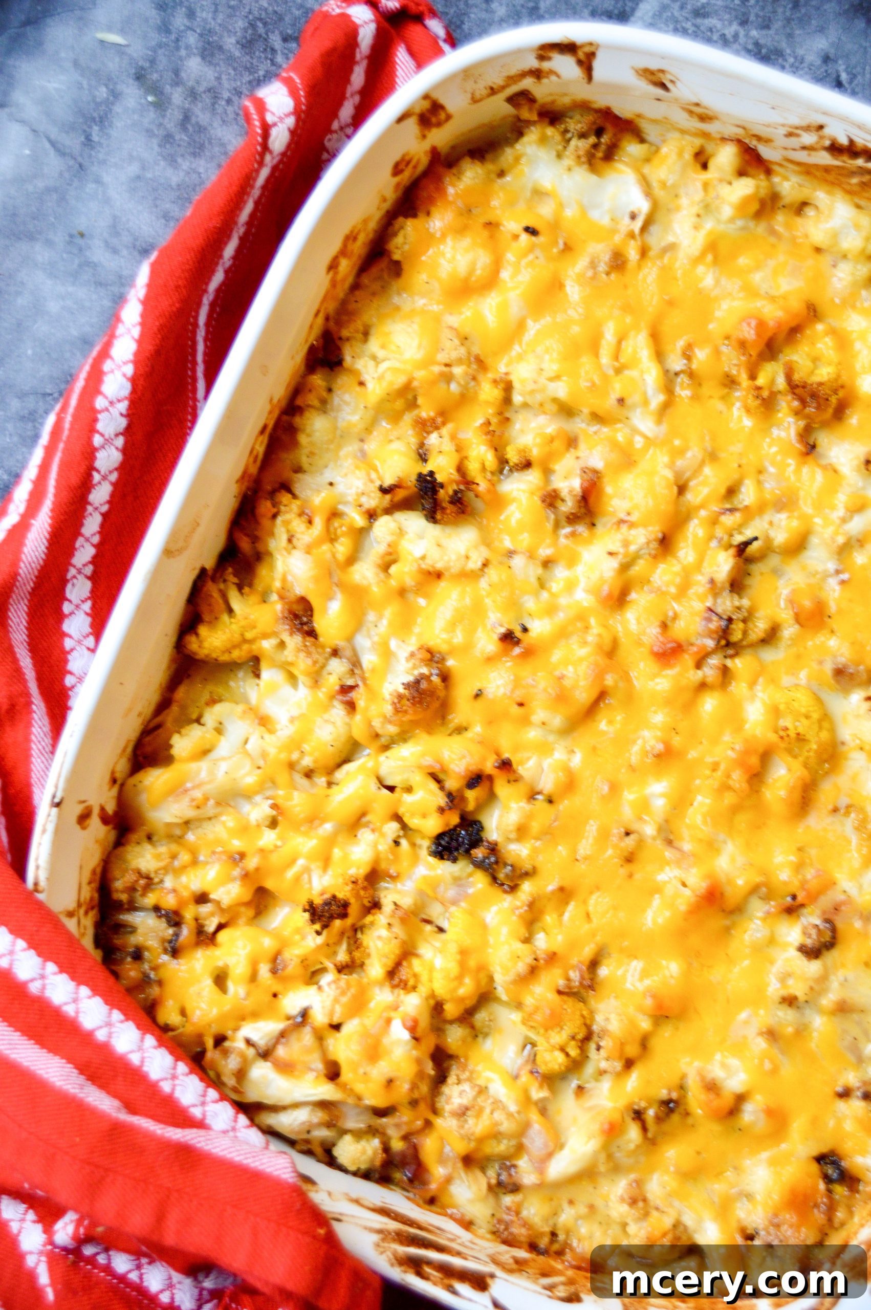 Golden Baked Cauliflower Mac & Cheese 3 A generous serving of cauliflower mac and cheese in a rustic ceramic bowl, ready to be enjoyed.
