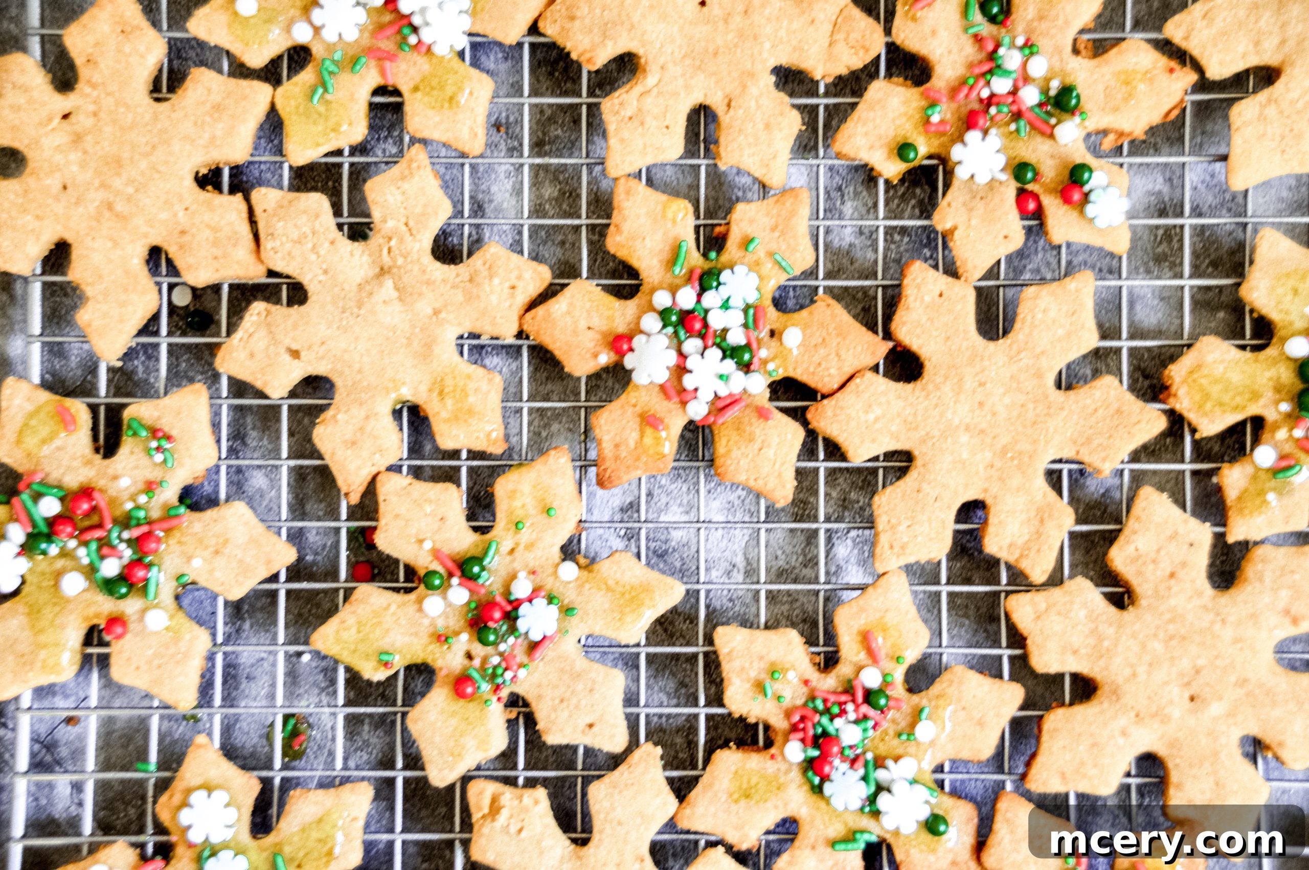 Guilt-Free Paleo Vegan Cut-Out Sugar Cookies 2 A perfectly baked, snowflake-shaped Paleo Cut-Out Skinny Sugar Cookie, glistening with a pale green icing and festive sprinkles, sits on a rustic wooden surface, hinting at holiday cheer.