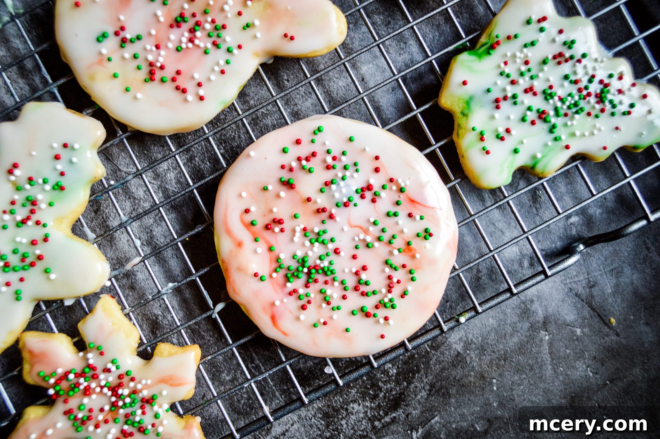 A collection of holiday-themed sugar cookies with marble glaze and sprinkles, perfectly arranged for a festive display.