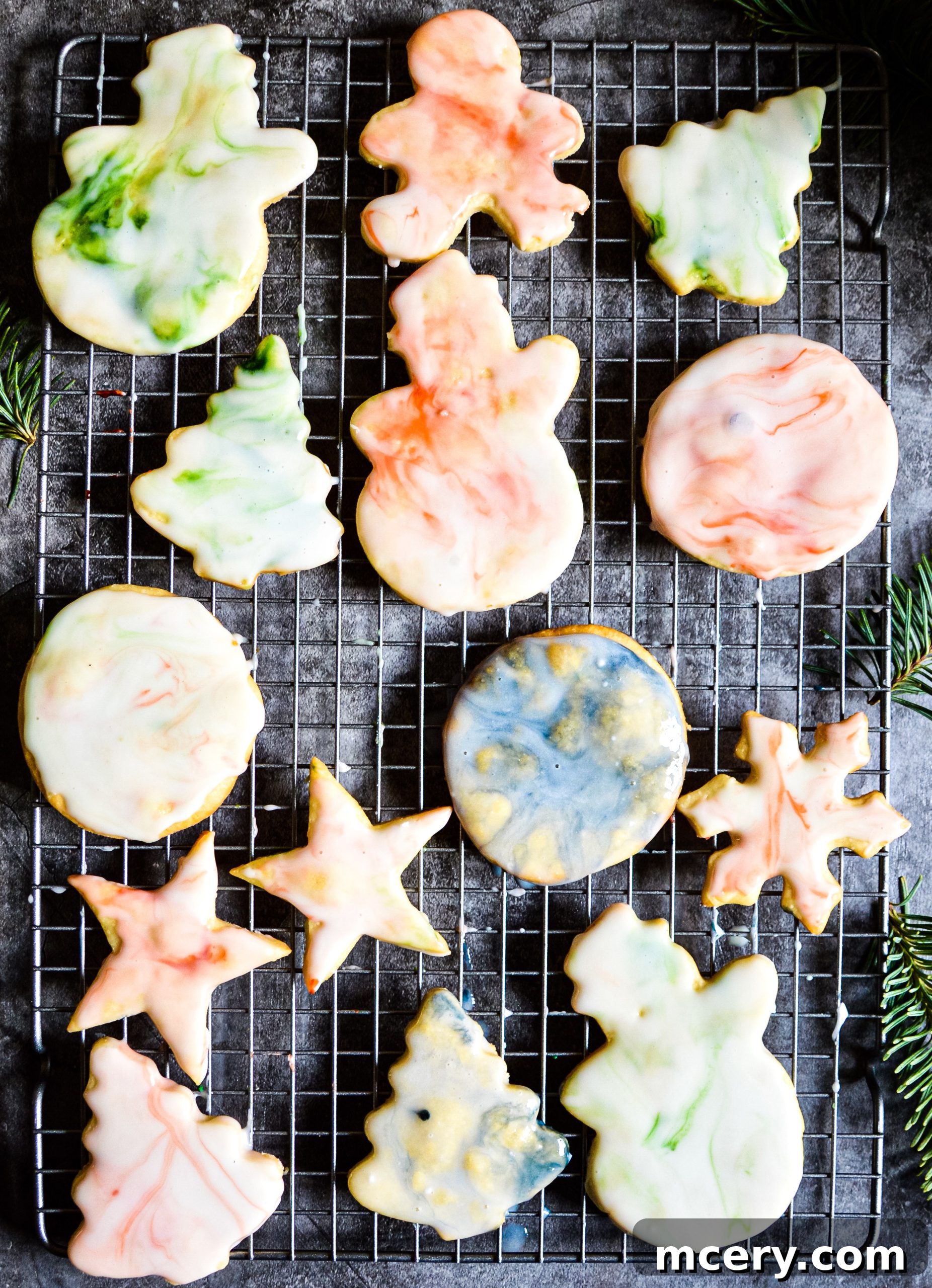 A close-up of a sugar cookie with a beautiful, swirling marble glaze in delicate pastel colors.