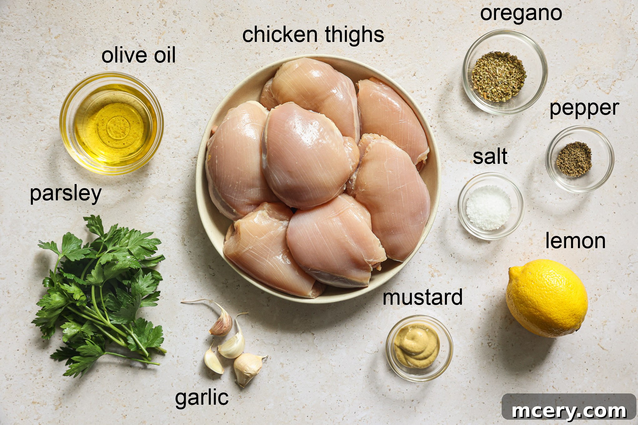Collection of fresh ingredients for making chicken skewers, including lemon, garlic, olive oil, and herbs.
