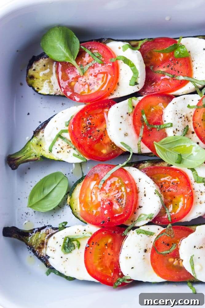Zucchini Mozzarella Melt 3 Close up of perfectly grilled zucchini topped with tomatoes, mozzarella, and basil