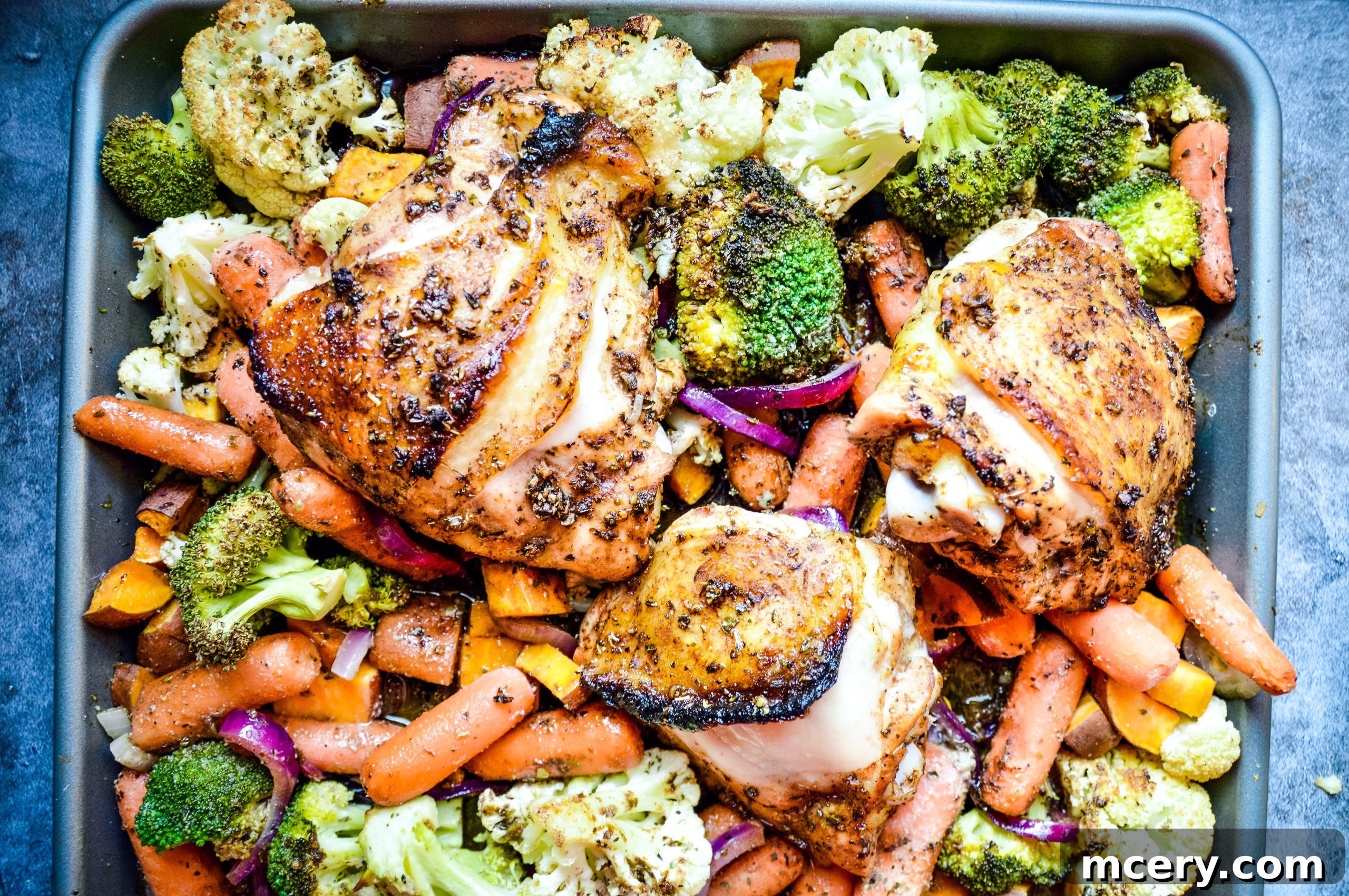 The finished Balsamic Honey Sheet Pan Chicken & Veggies, beautifully browned and garnished.