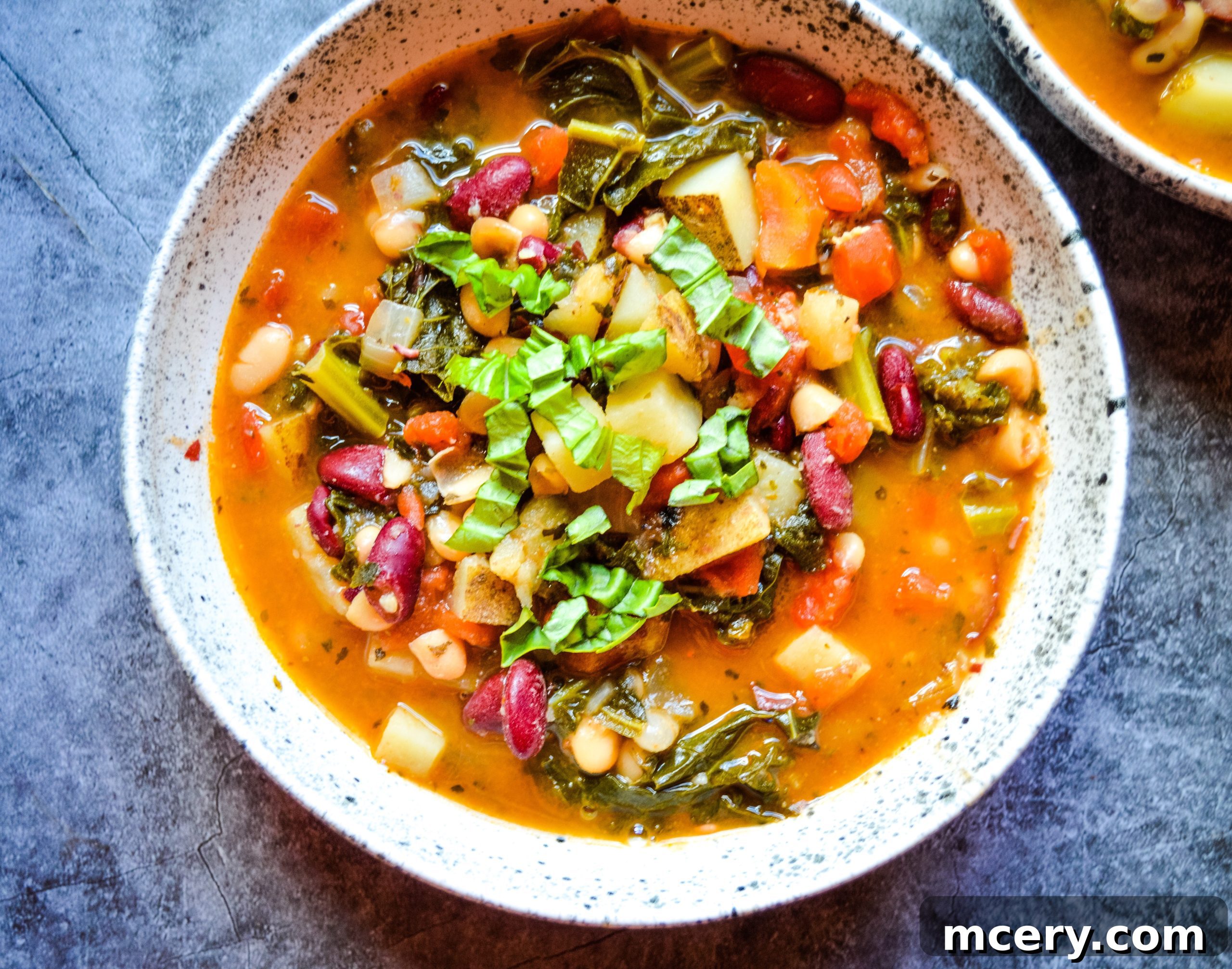Hearty Instant Pot Vegan Bean Potato Kale Soup 2 Vibrant Instant Pot Bean Potato & Kale Vegan Soup in a large pot, showing a rich broth with beans, potatoes, and kale.