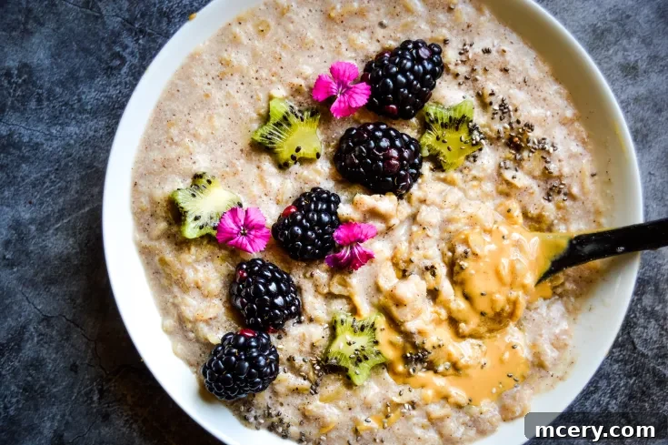 A beautifully arranged bowl of Banana Cinnamon Oatmeal with fresh fruit and nuts, suitable for Pinterest sharing.