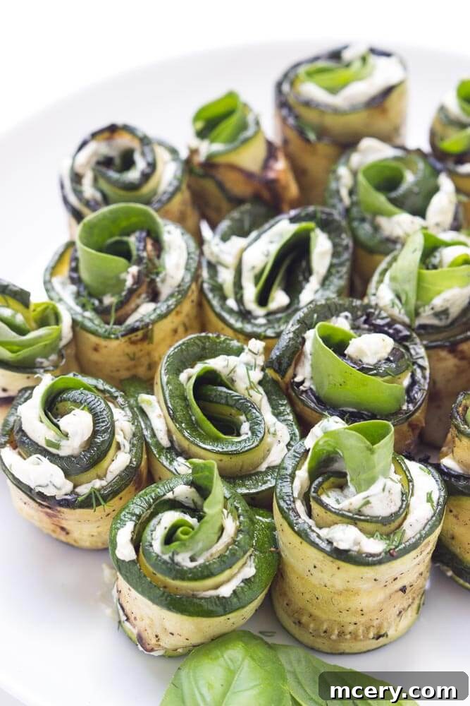 Creamy Zucchini Pinwheels 5 Close-up of a zucchini roll-up, filled with creamy herb cheese, ready to be enjoyed as a gourmet appetizer or healthy snack.