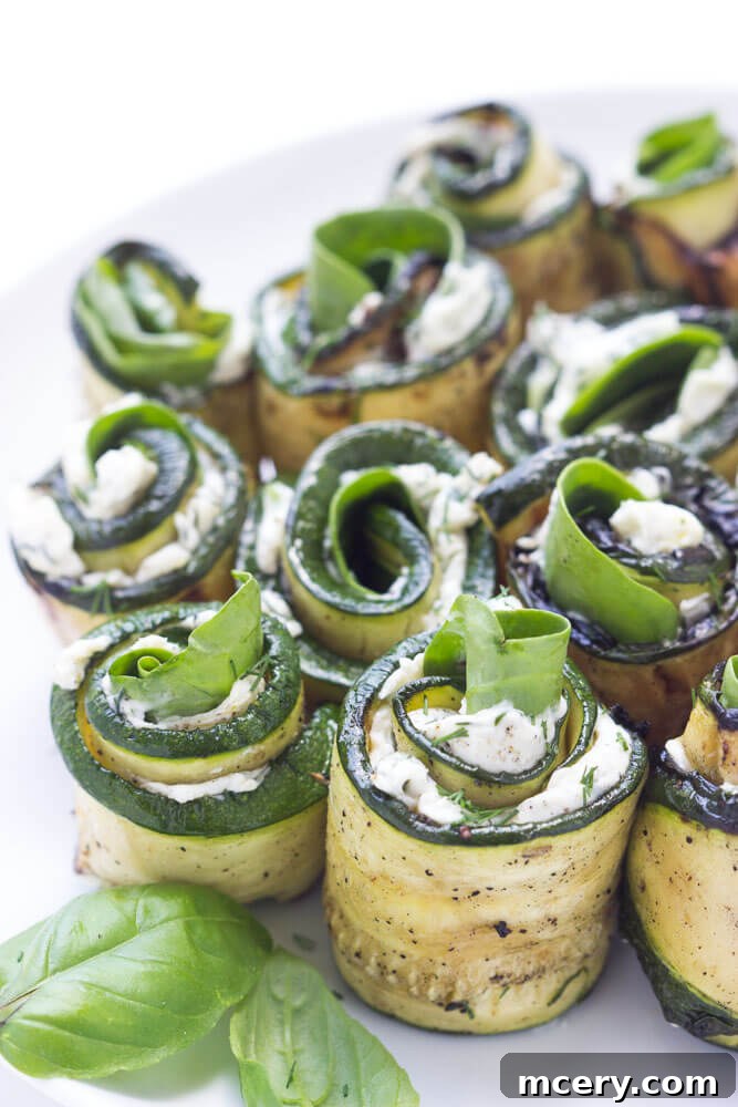 Creamy Zucchini Pinwheels 7 A vibrant display of grilled zucchini roll-ups, ready to be enjoyed as a refreshing appetizer or healthy side dish, perfect for picnics and gatherings.