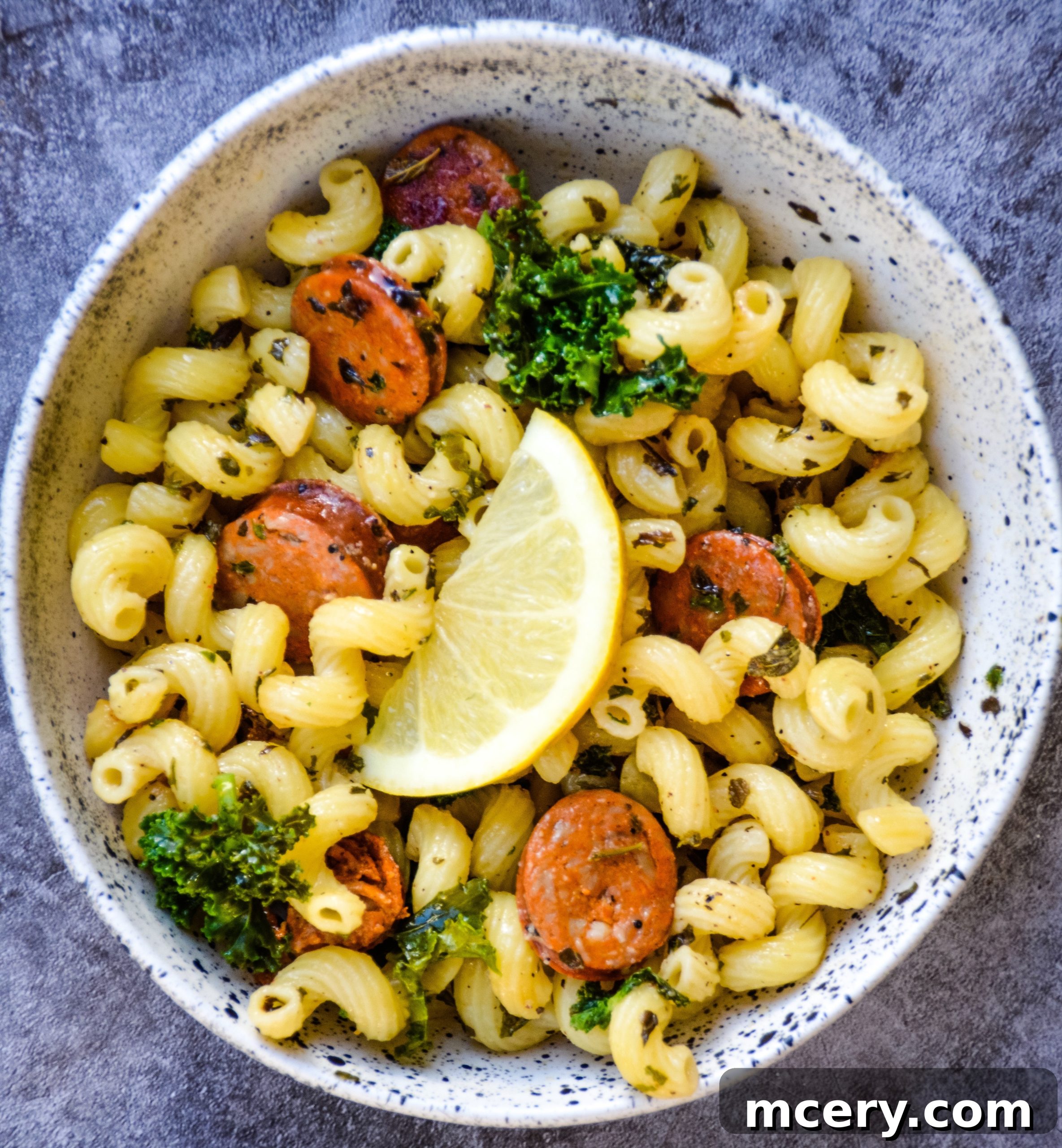 Zesty Lemon Sausage and Kale Pasta 3 Close-up of Lemon kale & sausage pasta in a skillet, showcasing the ingredients mixed together
