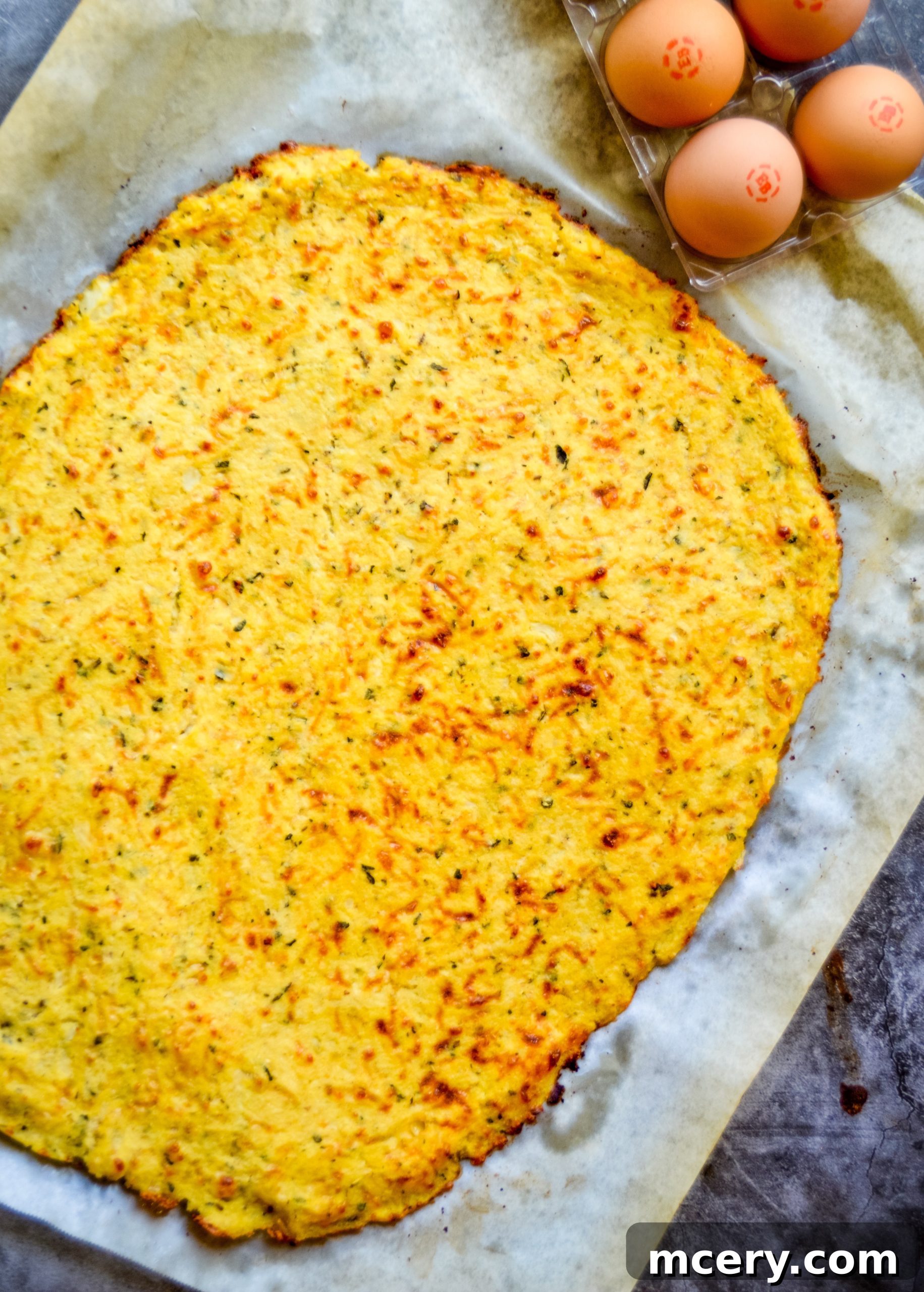 The Ultimate Cauliflower Pizza Base 12 A perfectly pre-baked, golden-brown cauliflower pizza crust.