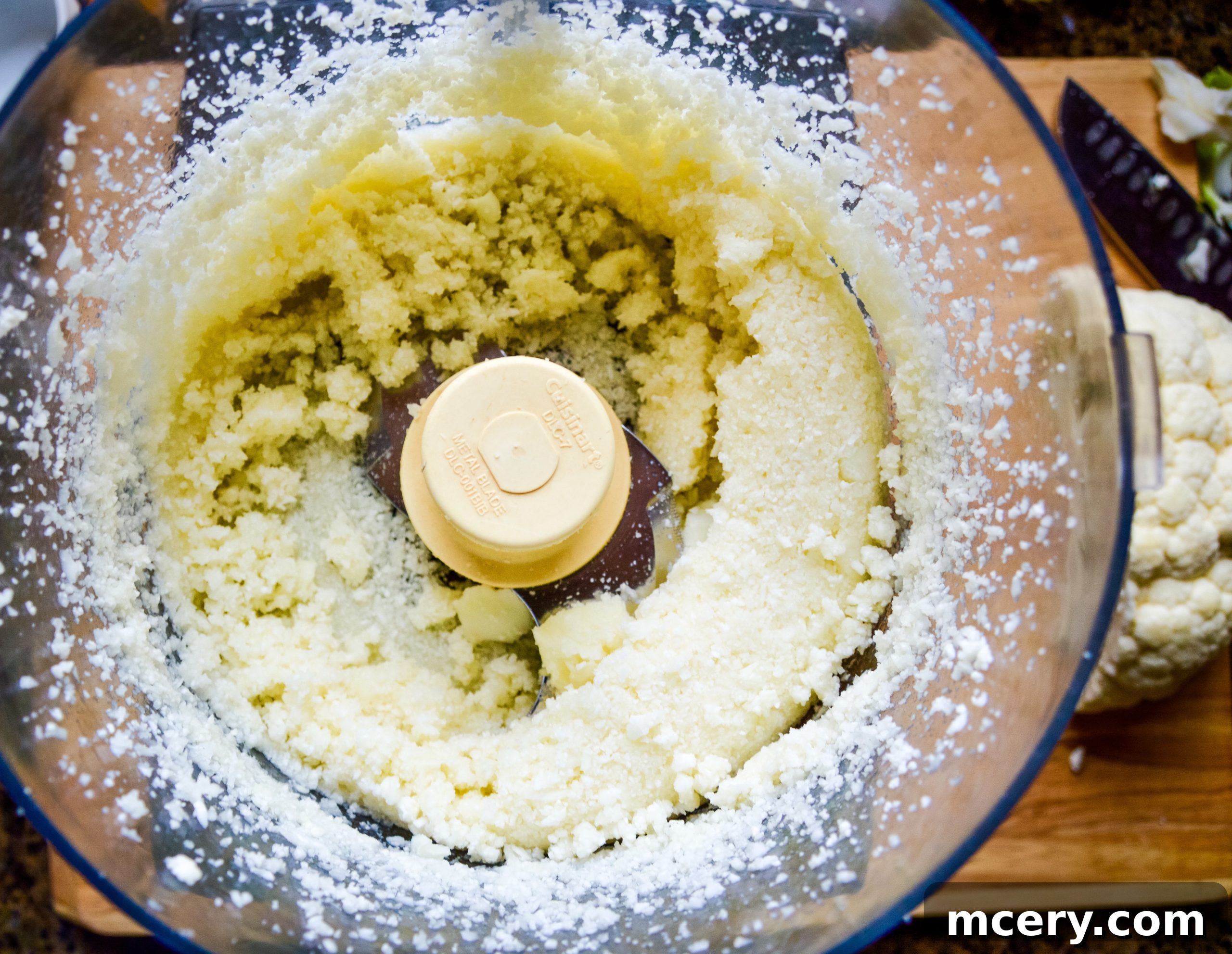 The Ultimate Cauliflower Pizza Base 7 Cauliflower rice spread in a non-stick pan on the stove.