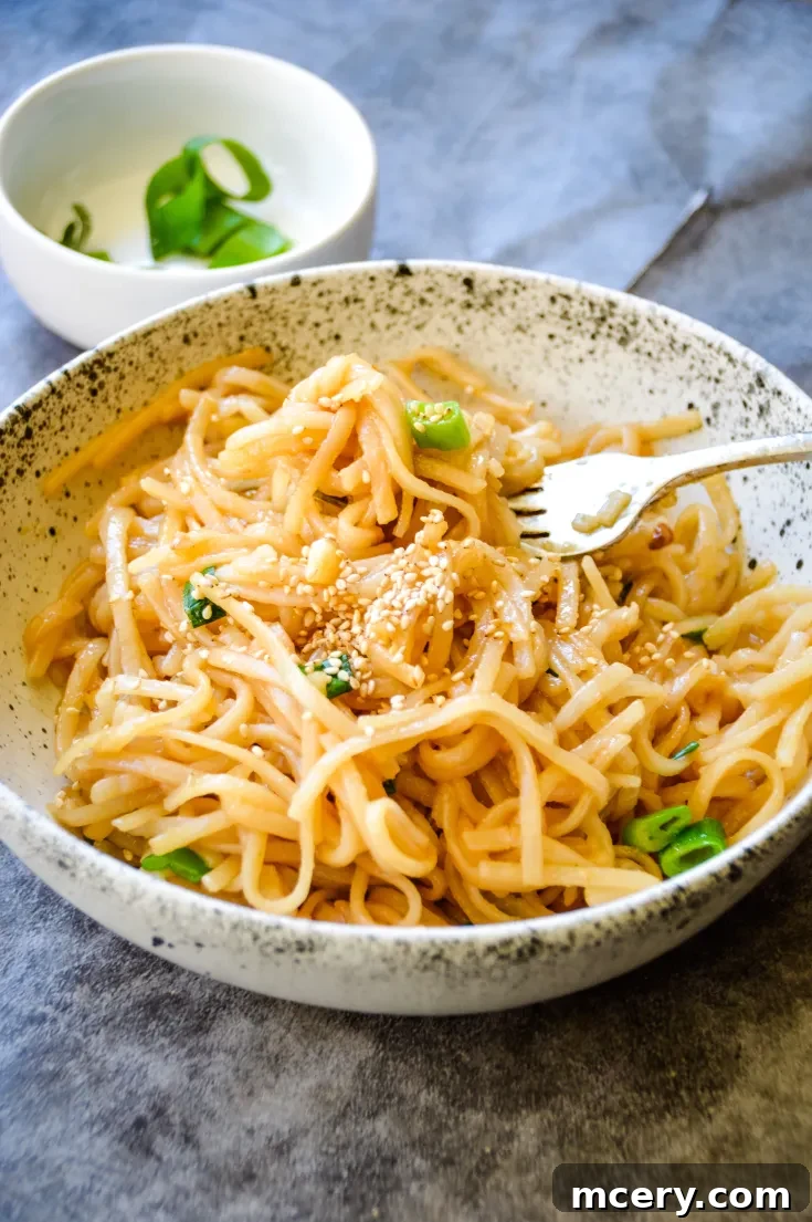 Asian Garlic Noodles on a plate with chopsticks.