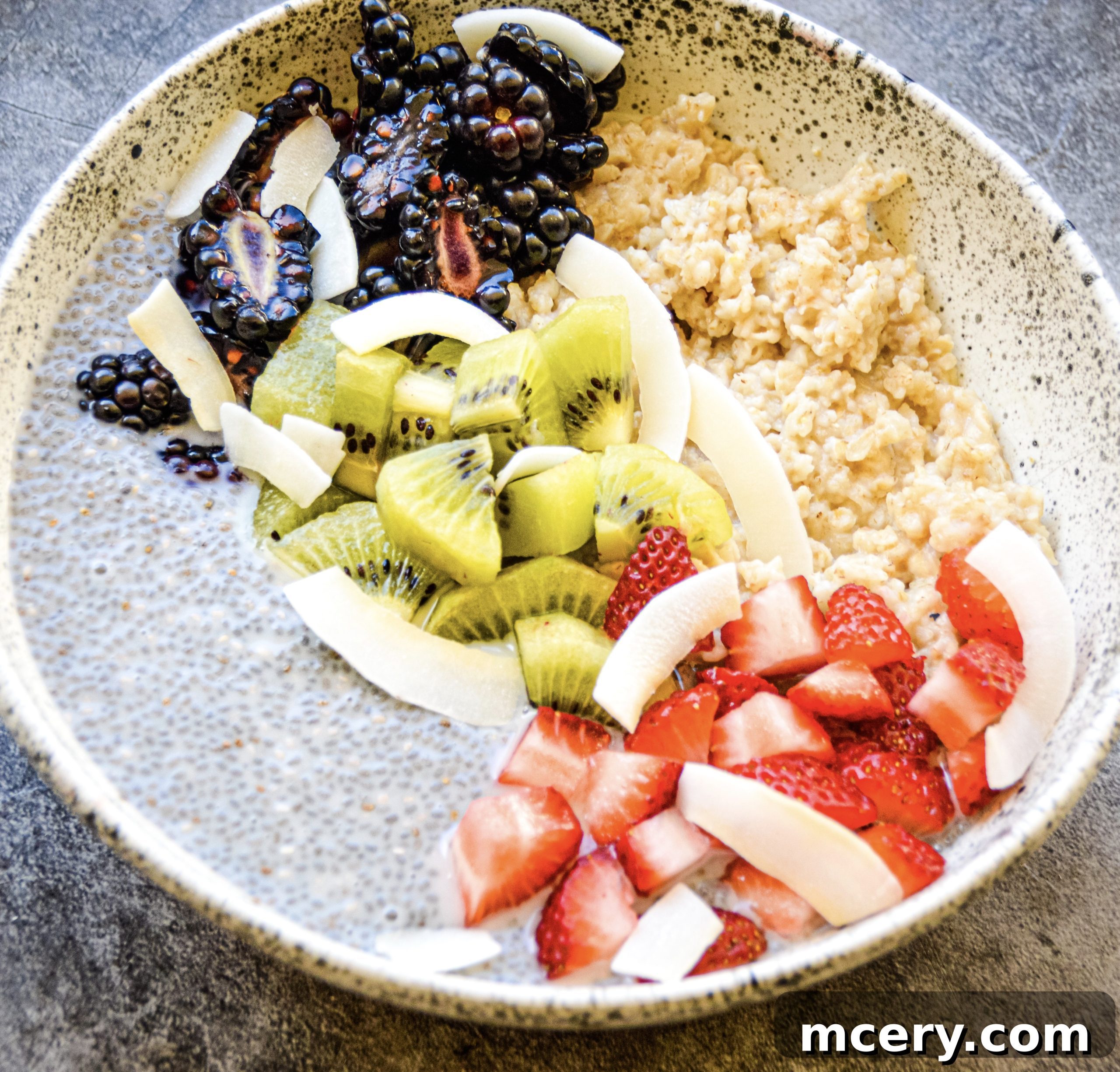 Wholesome Chia Oat Power Bowl 5 Overhead shot of a Chia Pudding and Oats Breakfast Bowl with a variety of colorful fruit toppings.