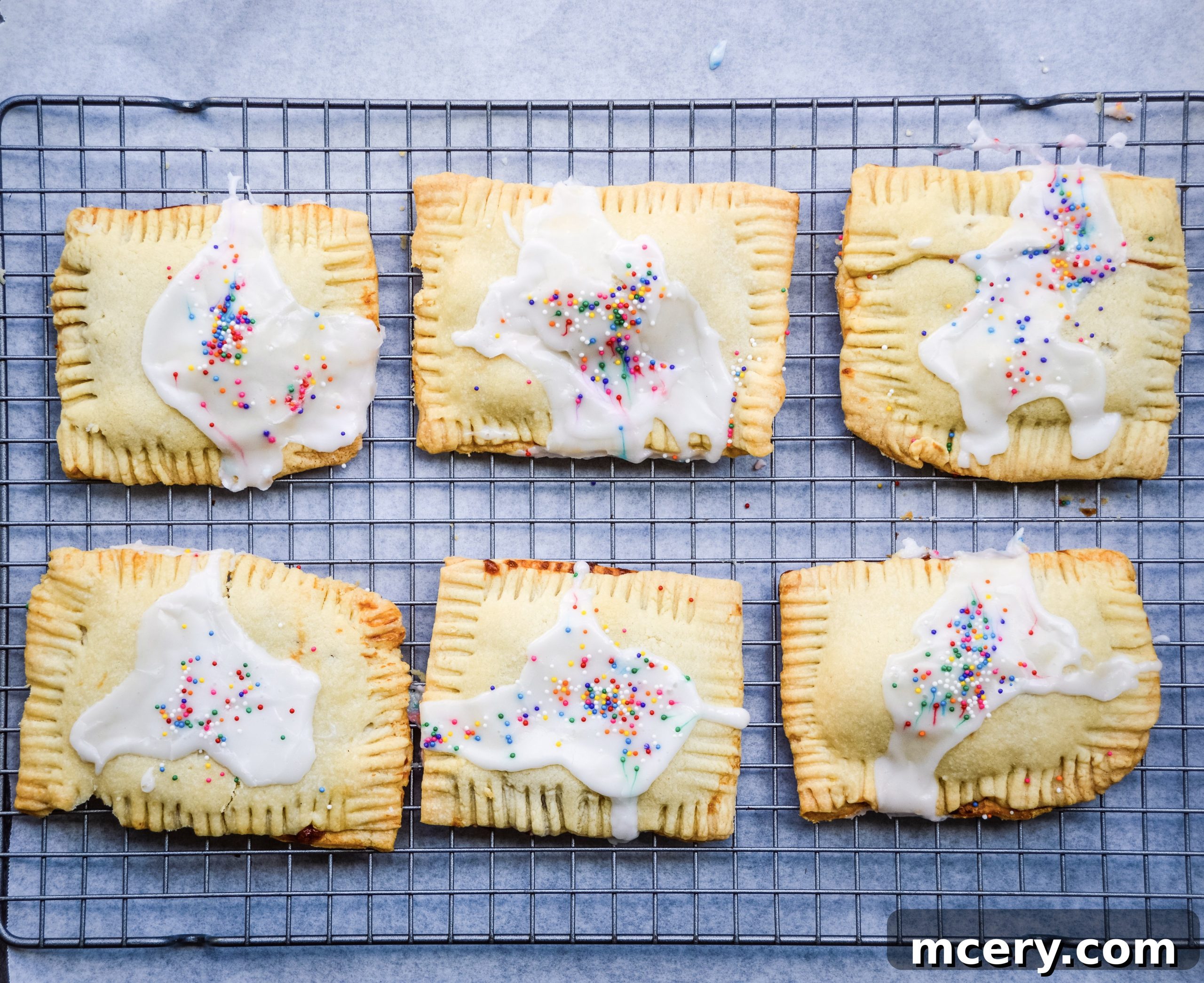 Sweet Strawberry Toaster Treat 5 Close-up of pop-tart edges being crimped with a fork, showing the raw pastry and jam filling.