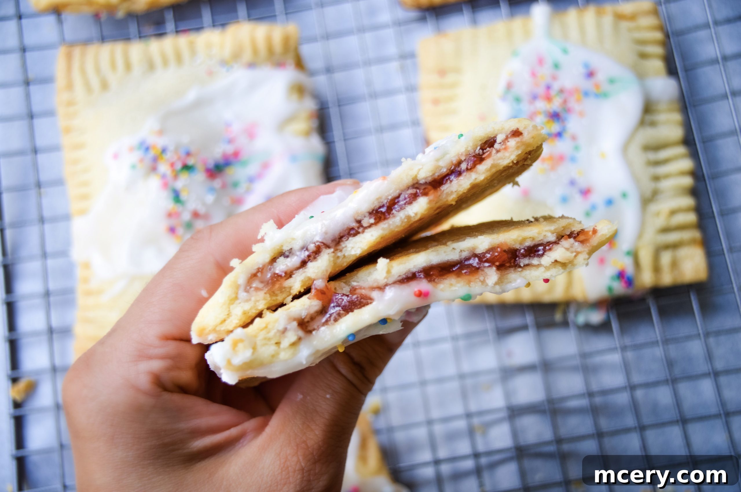 Sweet Strawberry Toaster Treat 6 Several homemade strawberry pop-tarts laid out on parchment paper, ready for baking.