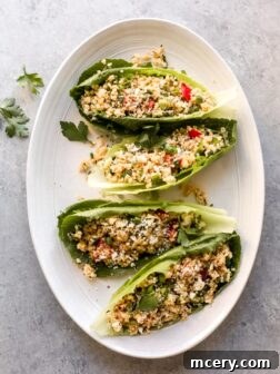 Mediterranean quinoa salad served inside crisp baby romaine leaves