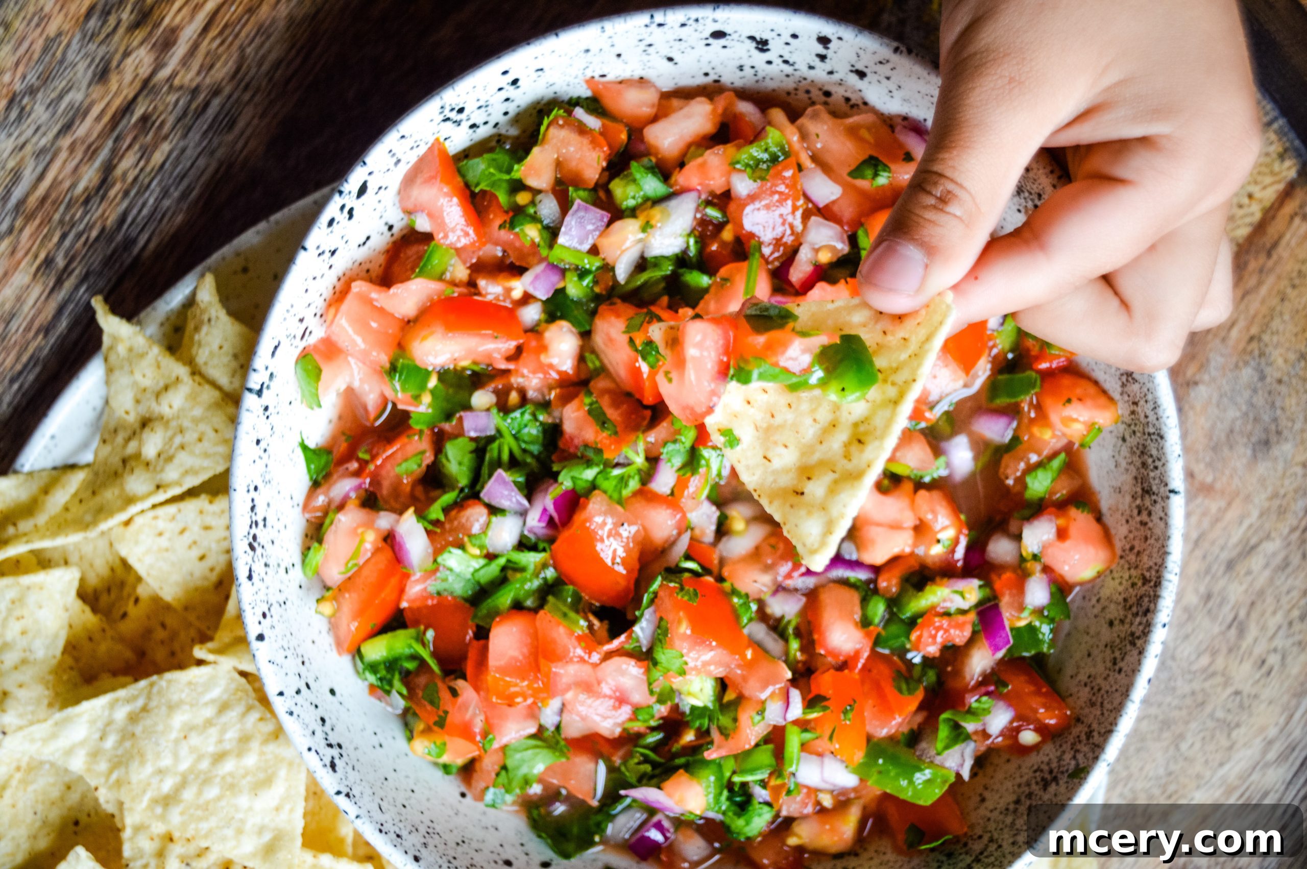 Zesty Garden Fresh Salsa 3 A top-down view of Pico de Gallo in a white bowl, highlighted by natural light, emphasizing the fresh textures of the ingredients.