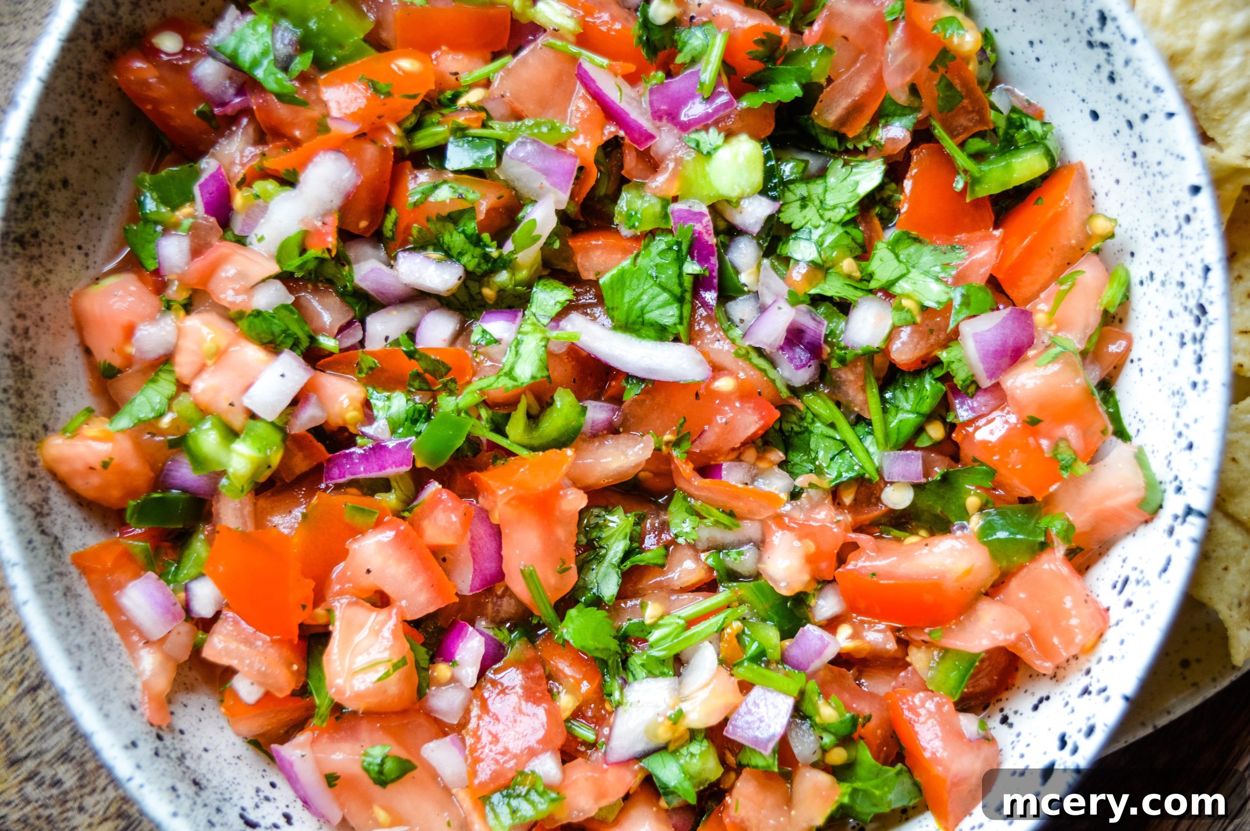 Zesty Garden Fresh Salsa 4 Ingredients for Pico de Gallo laid out on a cutting board, including fresh tomatoes, red onion, cilantro, and limes, ready for preparation.