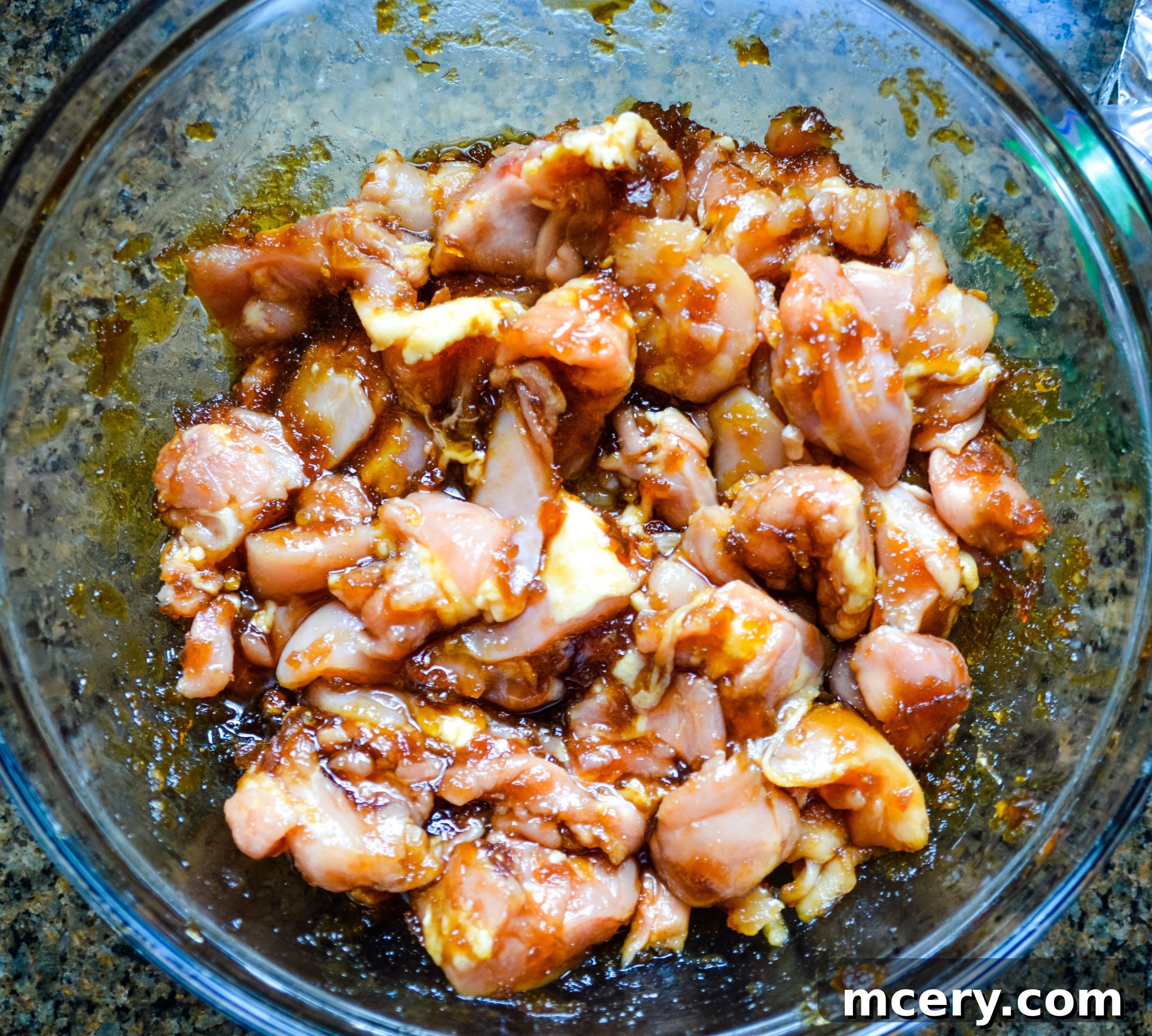 Sticky Teriyaki Chicken Skewers 5 Marinated chicken strips ready to be threaded onto skewers, showcasing the rich color of the teriyaki sauce.