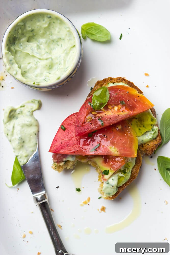 Summer Heirloom Tomato Stack 6 A delicious open-faced heirloom tomato sandwich with garlic-herb aioli, ready to be served, showcasing the beautiful layers of ingredients.