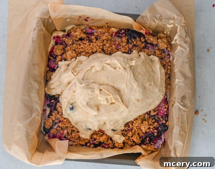 Moist Bakery Style Blueberry Burst Coffee Cake 11 First layer of cake batter spread in a baking pan.