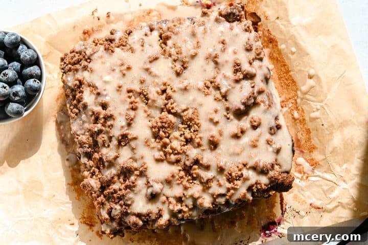 Moist Bakery Style Blueberry Burst Coffee Cake 13 Drizzling vanilla-lemon glaze over a warm blueberry coffee cake.