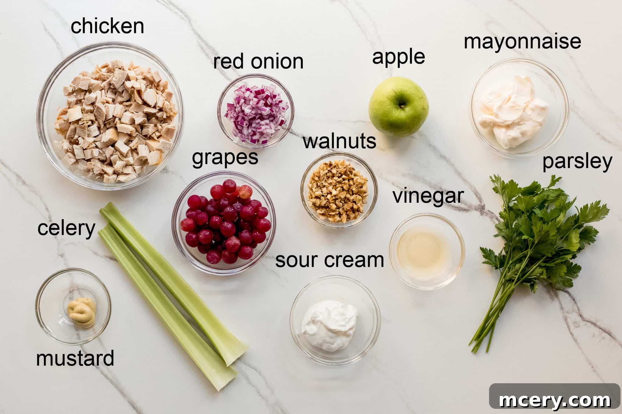 Crisp Apple Chicken Salad 4 A vibrant display of fresh ingredients required for making apple walnut chicken salad, including diced chicken, apples, and celery.