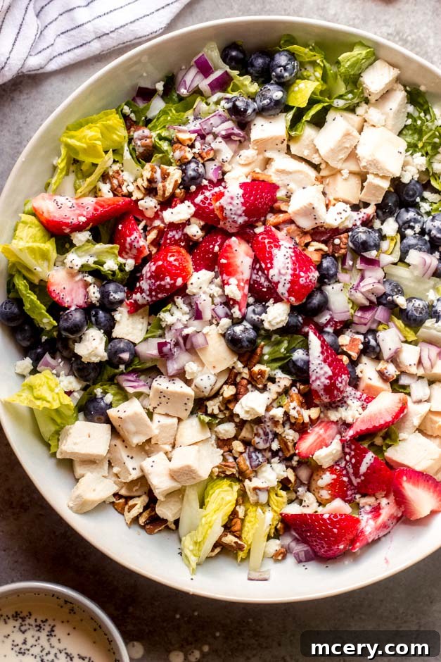 Refreshing Panera Strawberry Salad 5 Close-up of Panera-inspired strawberry poppyseed salad featuring romaine, berries, pecans, and feta.