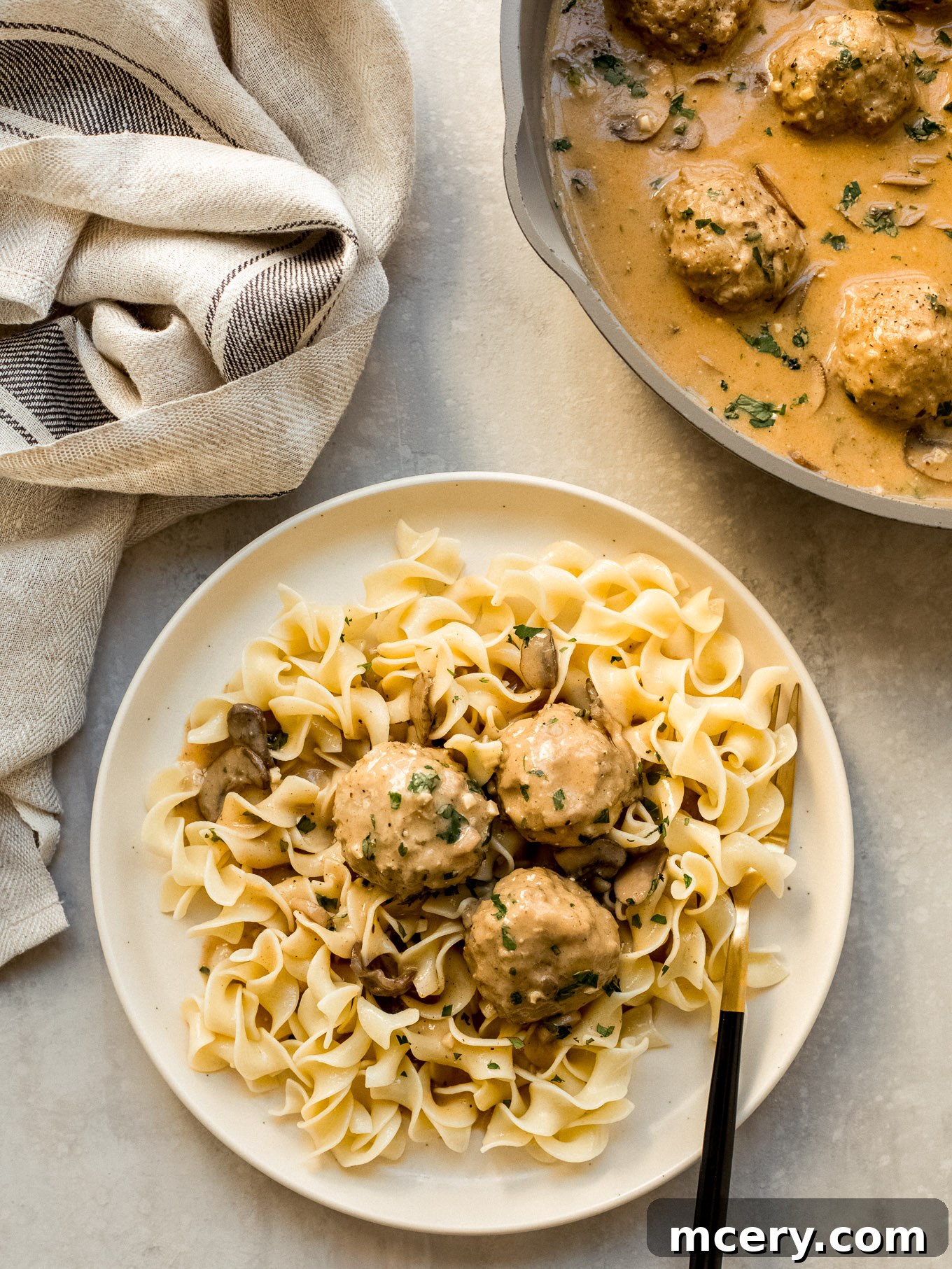 Creamy Chicken Meatball Stroganoff 2 chicken meatball stroganoff with egg noodles on a plate.